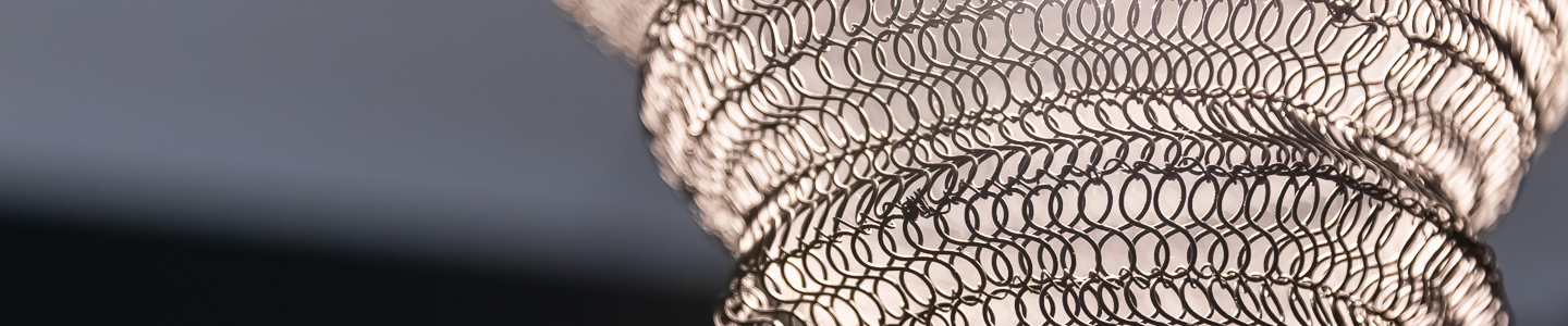 Close‑up of sculptural metal light fixture with overlapping circular loops