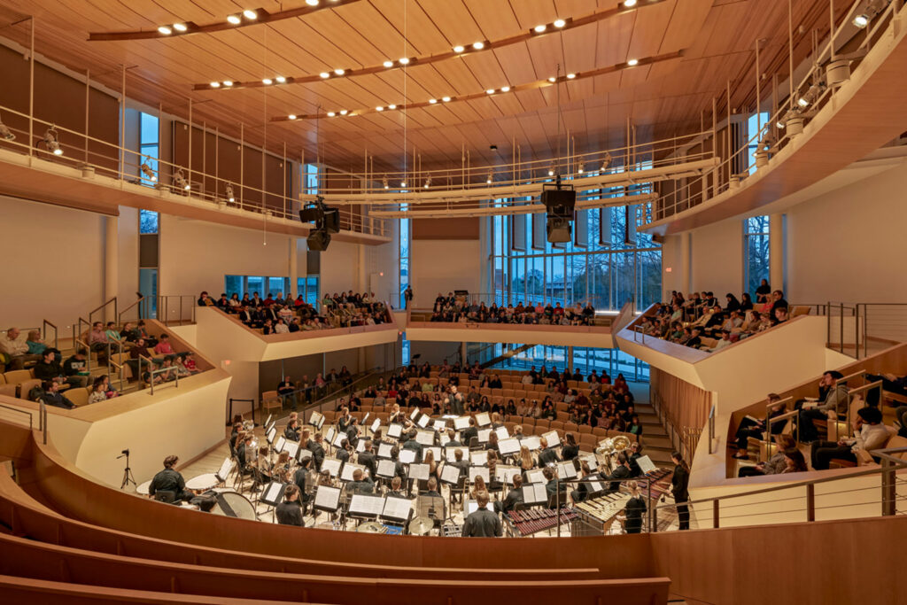 Live orchestral performance at Penn State University Recital Hall showcasing layered architectural lighting, acoustically designed interiors, and an immersive audience experience.